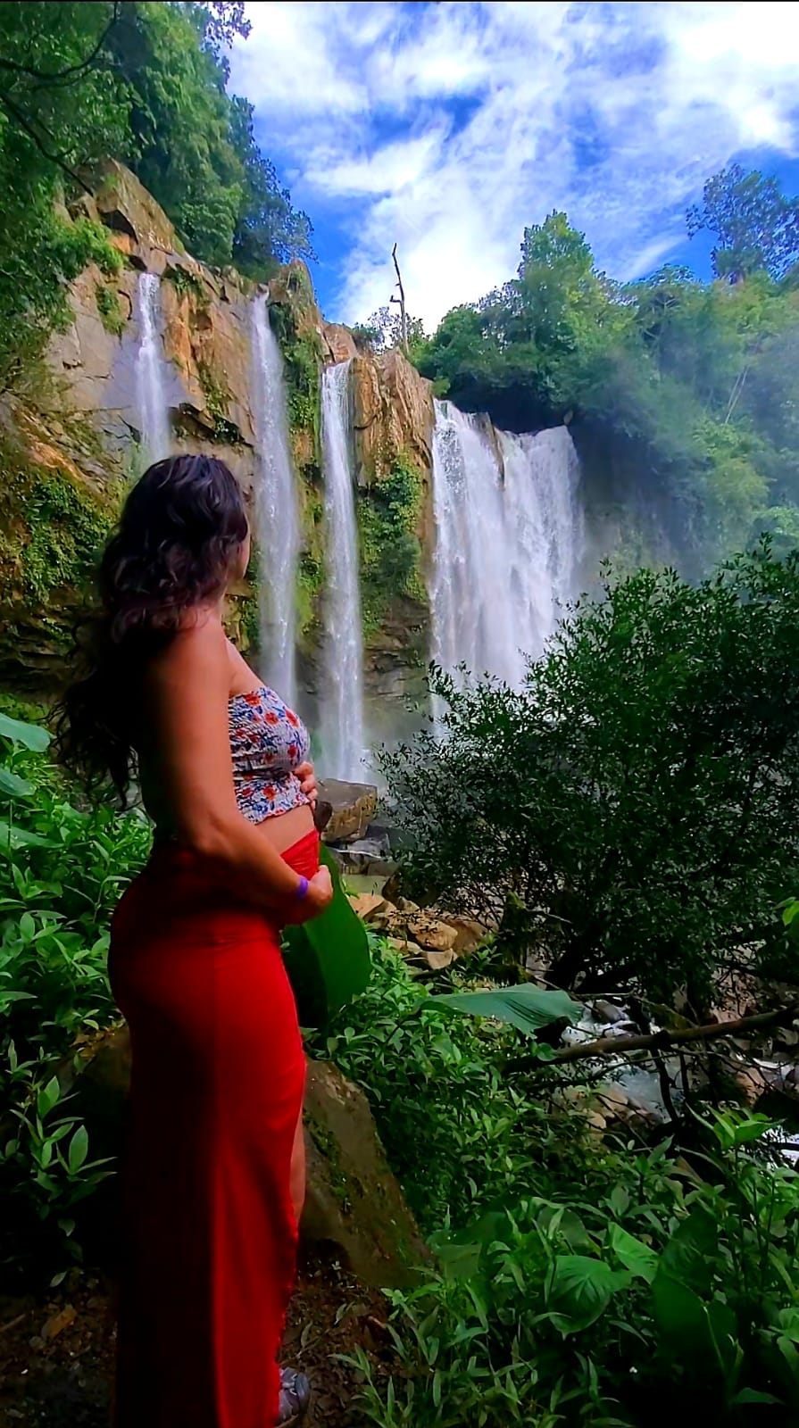 Adelina beside a waterfall
